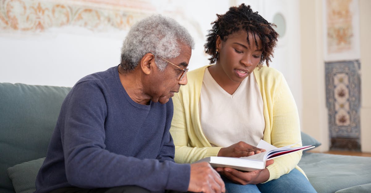 A senior man and caregiver engage in a meaningful conversation at home.